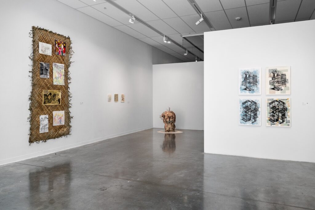 Multiple two-dimensional works of different mediums are displayed on the gallery walls, with one sculpture standing on the floor in a corner. One wall displays a quadriptych of drawings, and another wall displays a very large, woven surface with images on top of it. On the far side of the wall are a set of small two-dimensional works hung in a row. The room is filled with geometry, and the works share an organic nature through their materials and colour.